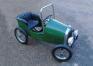 A green roadster child's pedal car